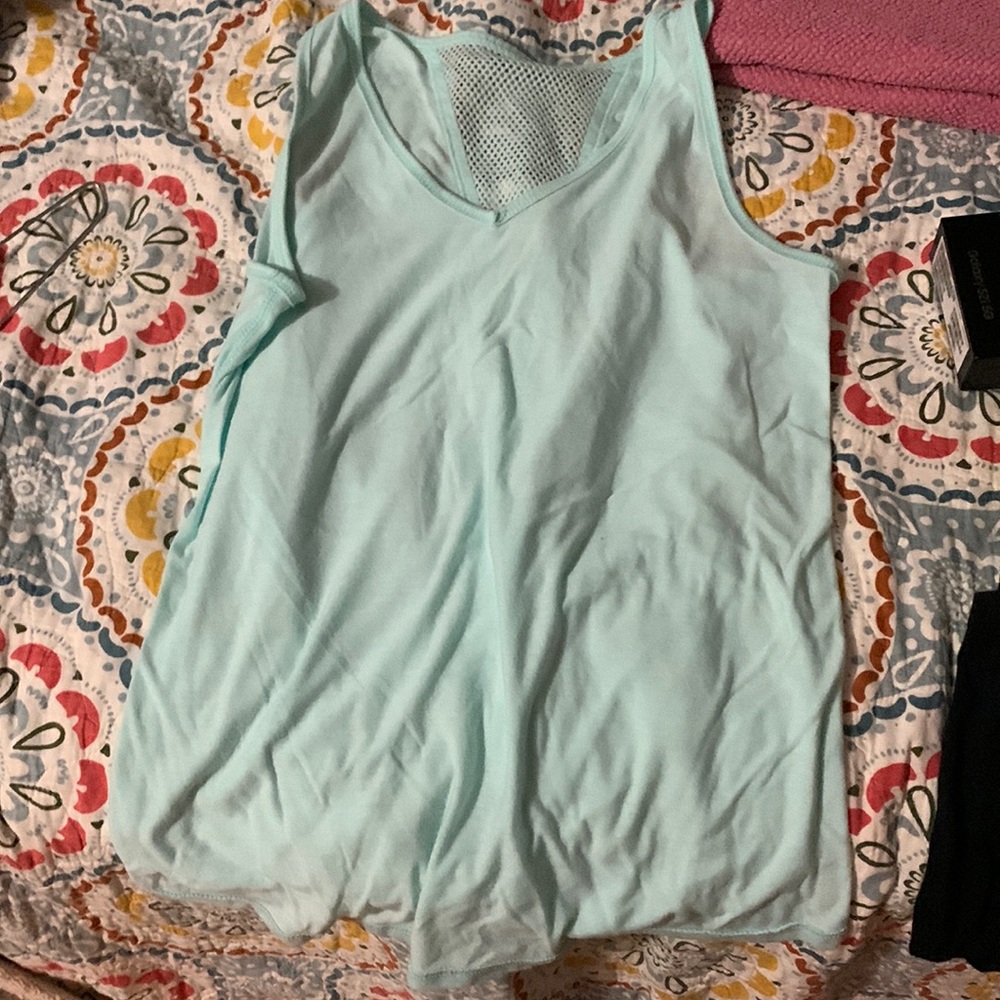 Teal tank top with a not in the back